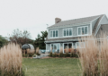 A large house sitting next to a lush green field