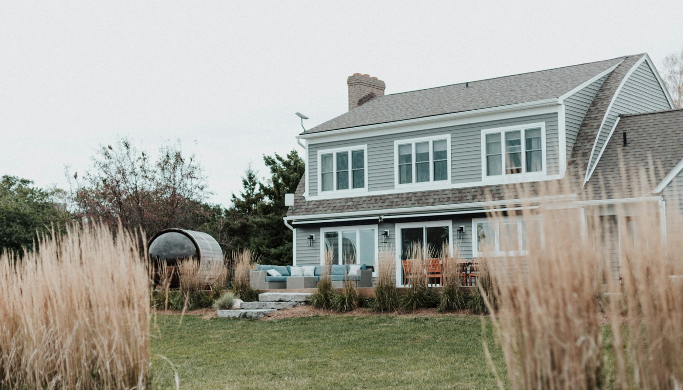 A large house sitting next to a lush green field