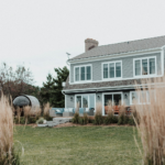 A large house sitting next to a lush green field