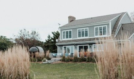 A large house sitting next to a lush green field