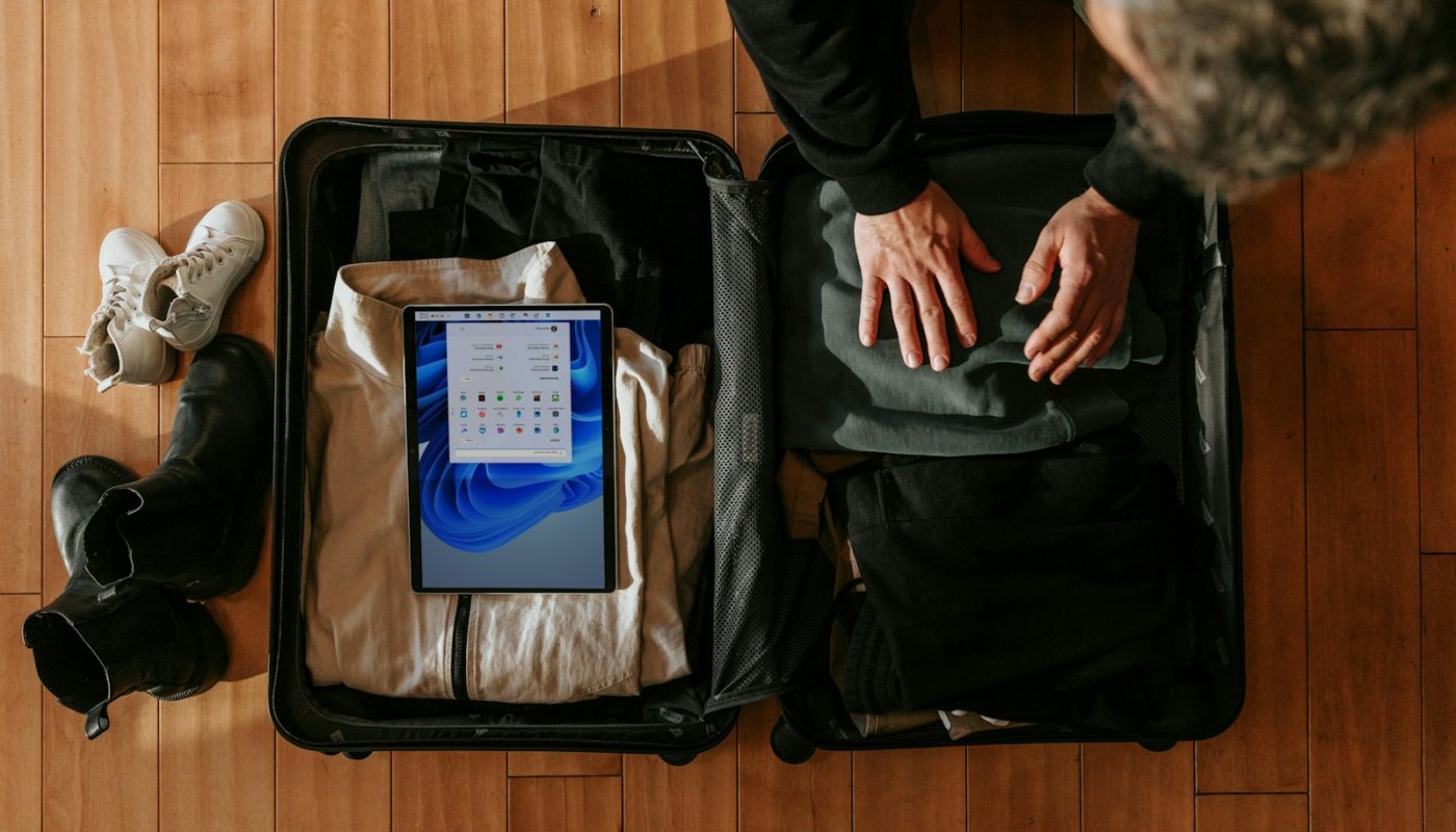 an overhead view of a person packing a suitcase