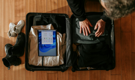 an overhead view of a person packing a suitcase