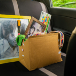 Box of items and framed pictures in car backseat