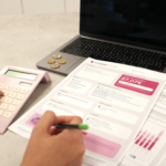 Someone is calculating their finances with documents.