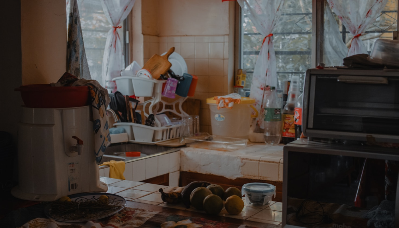A cluttered kitchen counter with dishes and appliances.