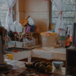 A cluttered kitchen counter with dishes and appliances.