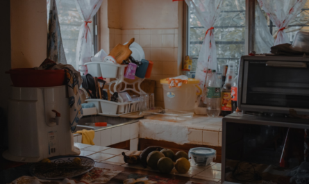 A cluttered kitchen counter with dishes and appliances.