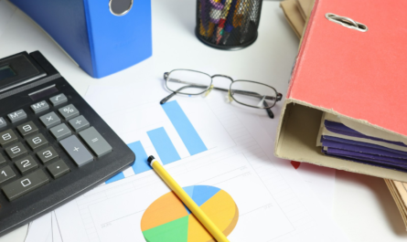 Desk with calculator, charts, and binders