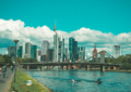 bridge over river near city buildings during daytime