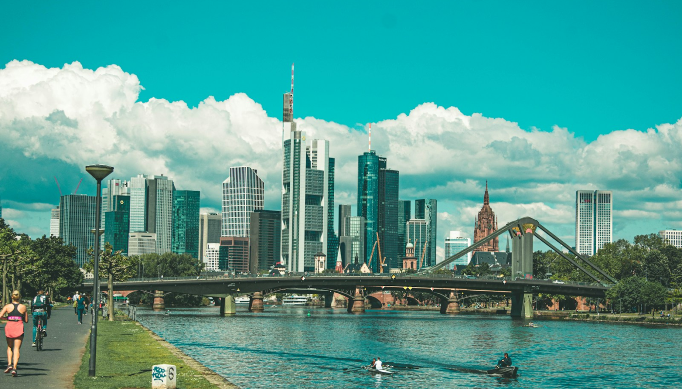 bridge over river near city buildings during daytime