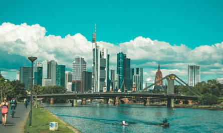 bridge over river near city buildings during daytime
