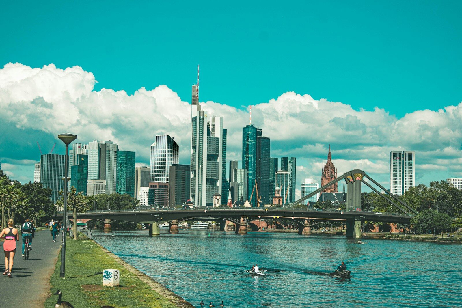 bridge over river near city buildings during daytime