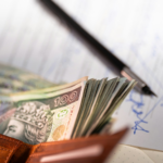 Stack of polish zloty banknotes in a wallet.