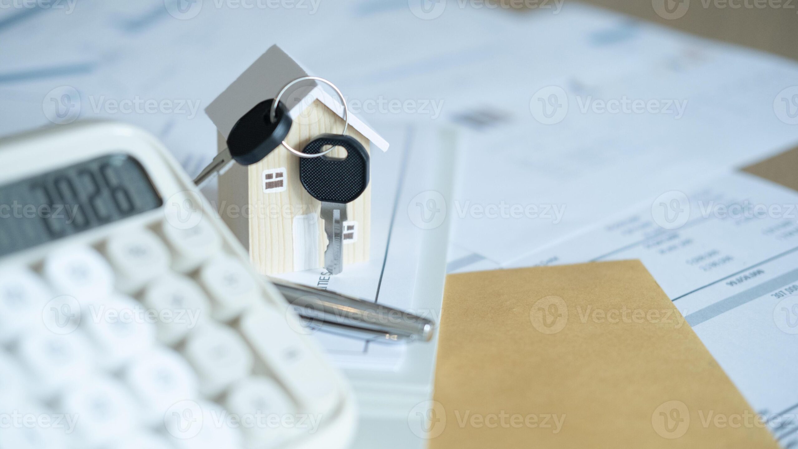 Homebuyer reviewing mortgage documents, house keys and budget planning