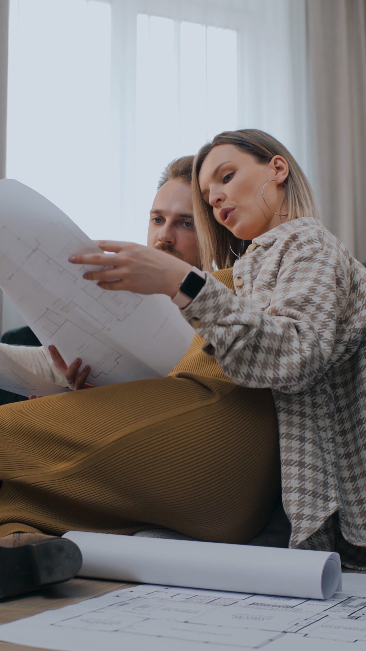 Couple planning a biweekly paycheck budget with a calculator