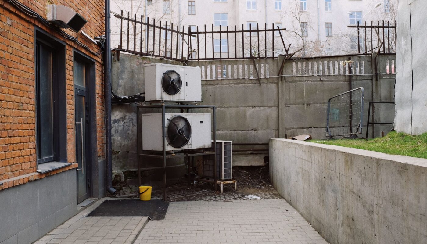 Outdoor heat pump unit beside a home for heating and cooling comparison