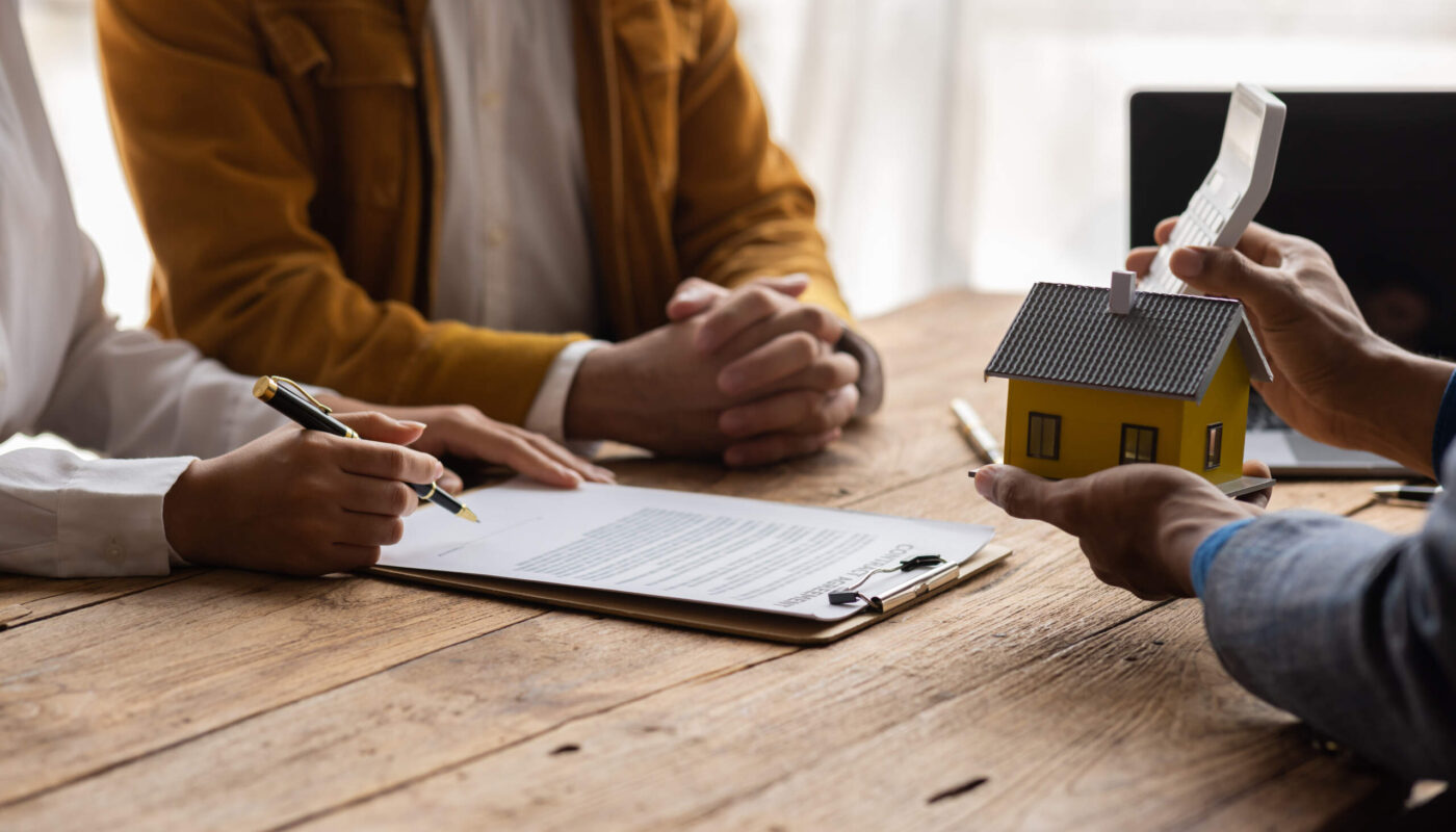 Mortgage closing documents, calculator and house keys for comparing closing costs